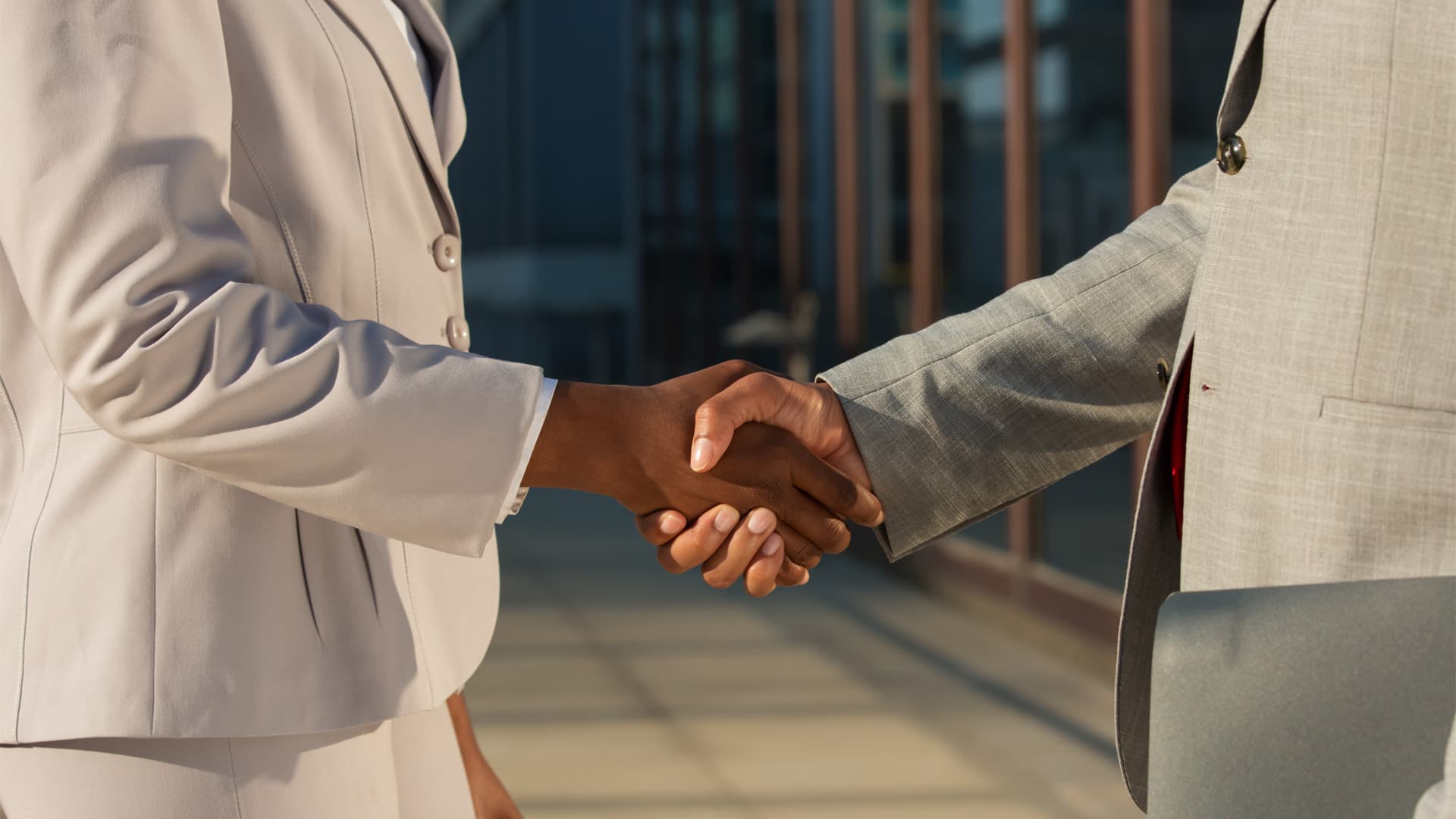 black-businesswoman-shaking-hands-with-male-partner